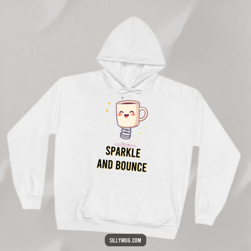 Funny hoodie featuring a happy mug bouncing on a spring, leaving a trail of sparkles, cozy and full of energy.